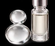 Clear droplets and a glass vial representing the aldehydic accord